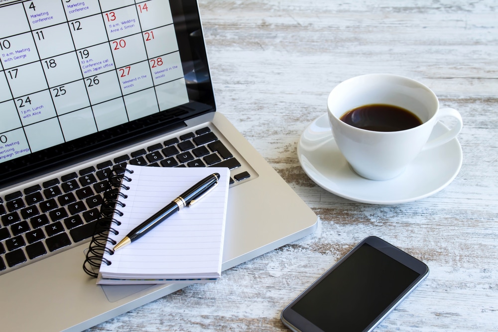 layout of notebook, laptop, phone and tea