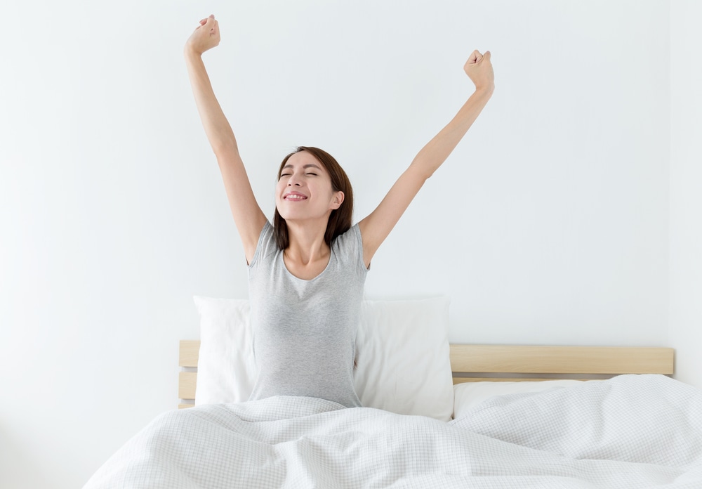 woman waking up and stretching