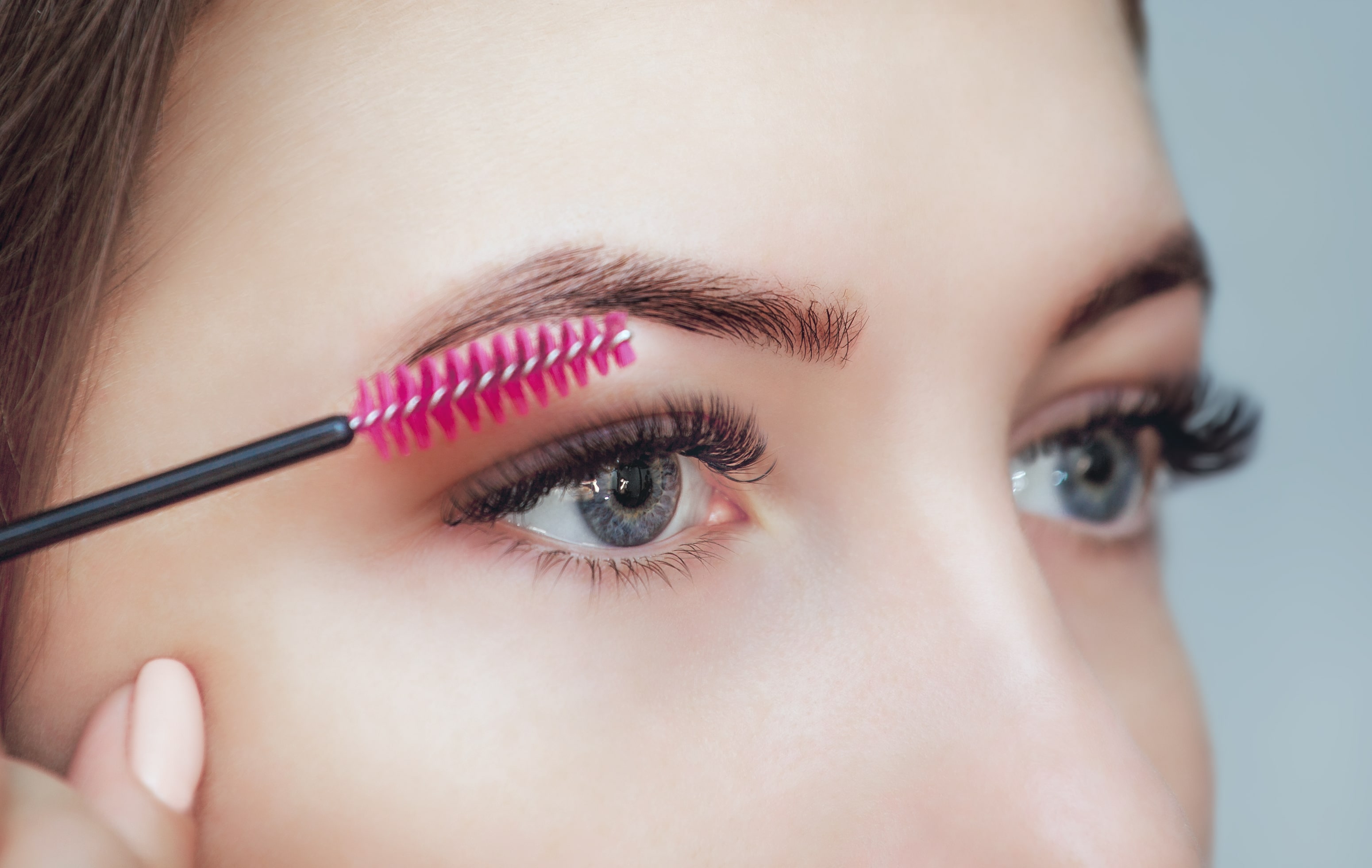 Woman brushing her eyelash extensions