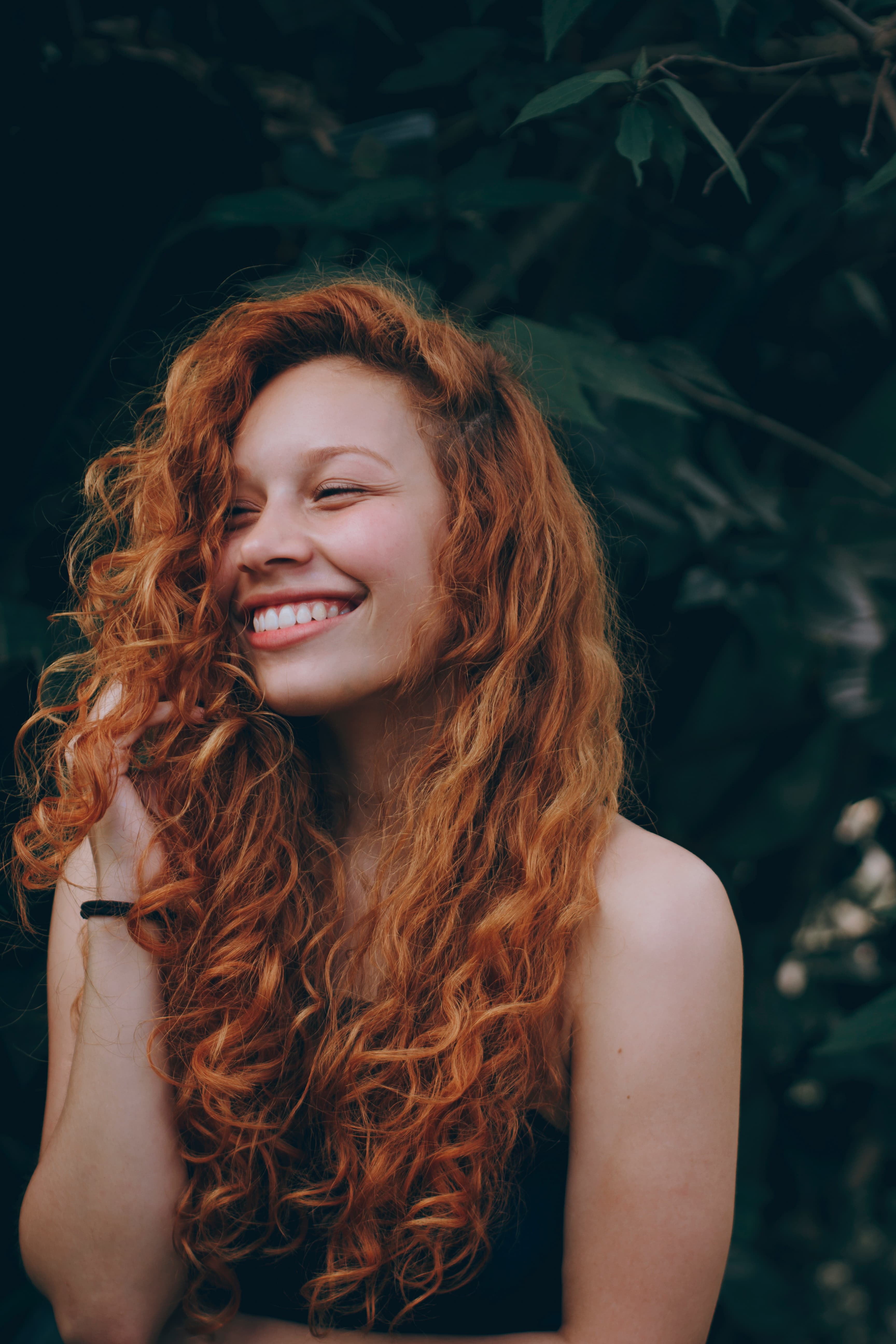 Woman with red hair smiling.