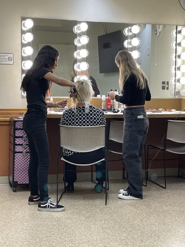 Bellus Academy team working at Salvation Army Fashion Show